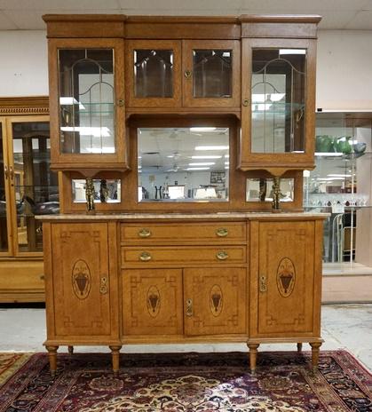 INLAID BIRDSEYE MAPLE MARBLE TOP SIDEBOARD: INLAID BIRDSEYE MAPLE MARBLE TOP SIDEBOARD, GLASS ON THE TWO TOP DOORS IS BEVELED. BRASS WINGED GRIFFINS SUPPORT THE TOP SECTION. MARBLE HAS BEEN REPAIRED. BASE HAS 2 DRAWERS & 4 DOORS, LEGS HAVE BRAS