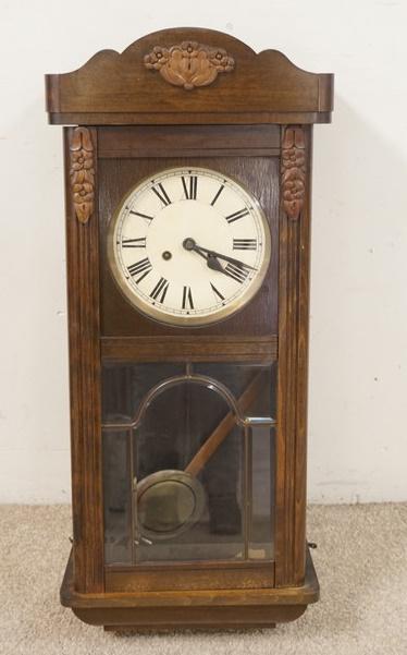 WALL CLOCK W/APPLIED FORAL CARVINGS: WALL CLOCK W/APPLIED FORAL CARVINGS, 13 1/2 IN WIDE X 30 1/2 IN HIGH