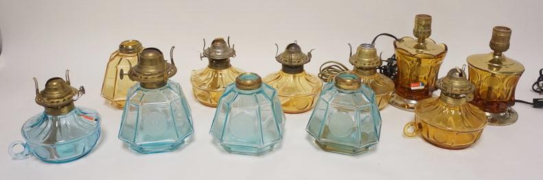 11 FOSTORIA COIN LAMPS: 11 FOSTORIA COIN LAMPS, 4 LIGHT BLUE & 7 AMBER, 3 ARE ELECRIC, 3 DON'T HAVE BURNERS