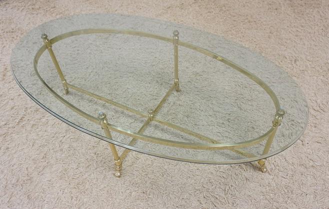 FANCY OVAL BRASS W/GLASS TOP COFFEE TABLE: FANCY OVAL BRASS W/GLASS TOP COFFEE TABLE, 27 1/7 IN X 48 1/2 IN X 16 IN