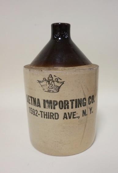 HALF GALLON ADVERTISING JUG: HALF GALLON ADVERTISING JUG, AETNA IMPORTING CO 1592 THIRD AVE NY, HAS A TIGHT HAIRLINE, 9 IN HIGH