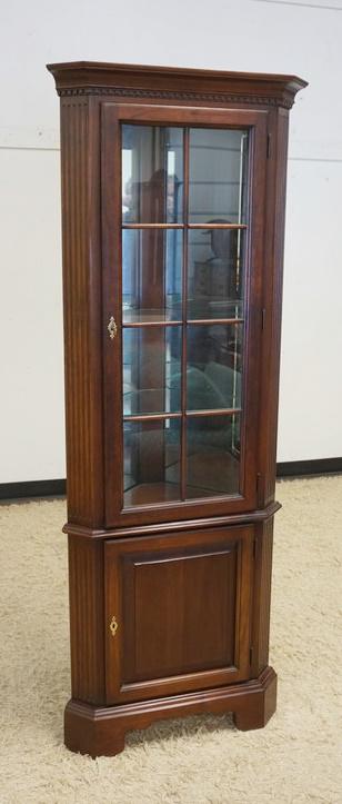 DIMINUTIVE BLACK CHERRY CORNER CURIO: DIMINUTIVE BLACK CHERRY CORNER CURIO, REEDED COLUMN W/INTERIOR LIGHT, GLASS SHELVES & MIRRORED BACK, APPROXIMATELY 27 IN X 16 IN X 72 IN HIGH