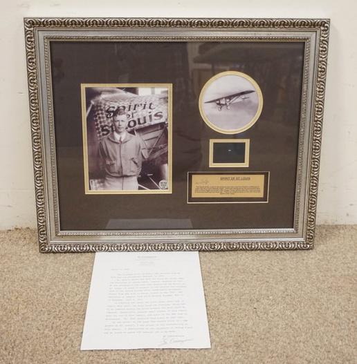 SPIRIT OF ST LOUIS FRAMED MEMMORABILIA: SPIRIT OF ST LOUIS FRAMED MEMMORABILIA; PHOTOS OF OF CHARLES LINDBERGH & THE SPIRIT OF SAINT LOUIS, & A SMALL PIECE OF FABRIC TAKEN FROM THE PLANE. ALSO HAS COA SIGNED BY EV CASSAGNERES AUTHOR OF THE 