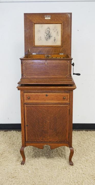 REGINA MUSIC BOX IN OAK CASE: REGINA MUSIC BOX IN OAK CASE ON OAK STAND, ONE DRAWER, ONE PULL OUT SLIDE & 1 DOOR FOR ADDITIONAL DISCS, ONE DISC INCLUDED, C.J. HEPPE & SON PHILADELPHIA, #67314, MUSIC BOX APPROXIMATELY 22 IN X 20 IN