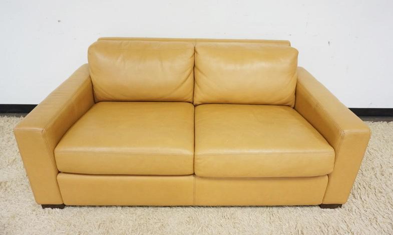 DESIGN WITHIN REACH AMERICAN LEATHER LOVE SEAT: DESIGN WITHIN REACH AMERICAN LEATHER LOVE SEAT, SCRATCHES TO TOP, BACK AND SIDES, APPROXIMATELY 66 IN X 37 IN X 29 IN H