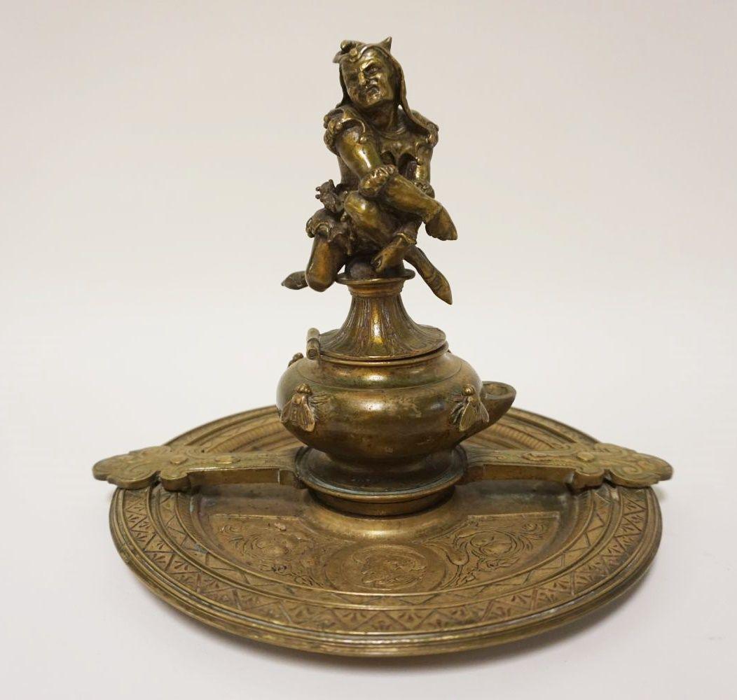 ANTIQUE ORNATE BRASS INKWELL: ANTIQUE ORNATE BRASS INKWELL W/FIGURE OF A COURT JESTER ON TOP OF HINGED LID, INKWELL REVOLVES ON BASE 360 DEGREES, APPROXIMATELY 10 IN X 8 IN HIGH