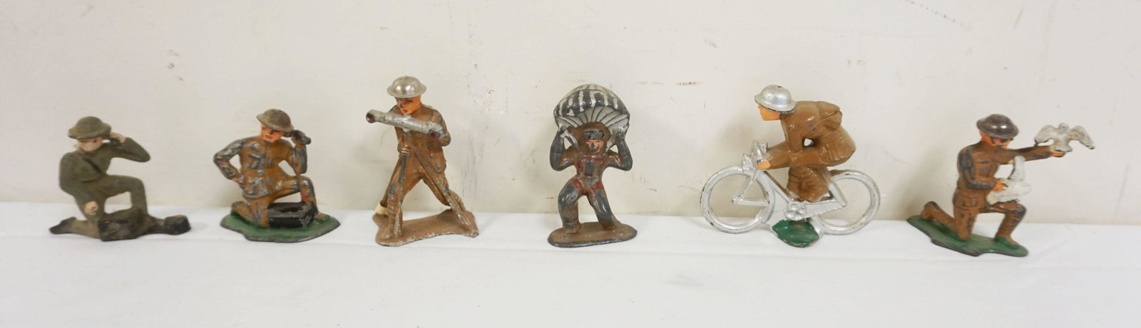 LOT OF 6 ANTIQUE CAST METAL WWI SOLDIERS: LOT OF 6 ANTIQUE CAST METAL WWI SOLDIERS, BIKE RIDER, PARACHUTE, ETC