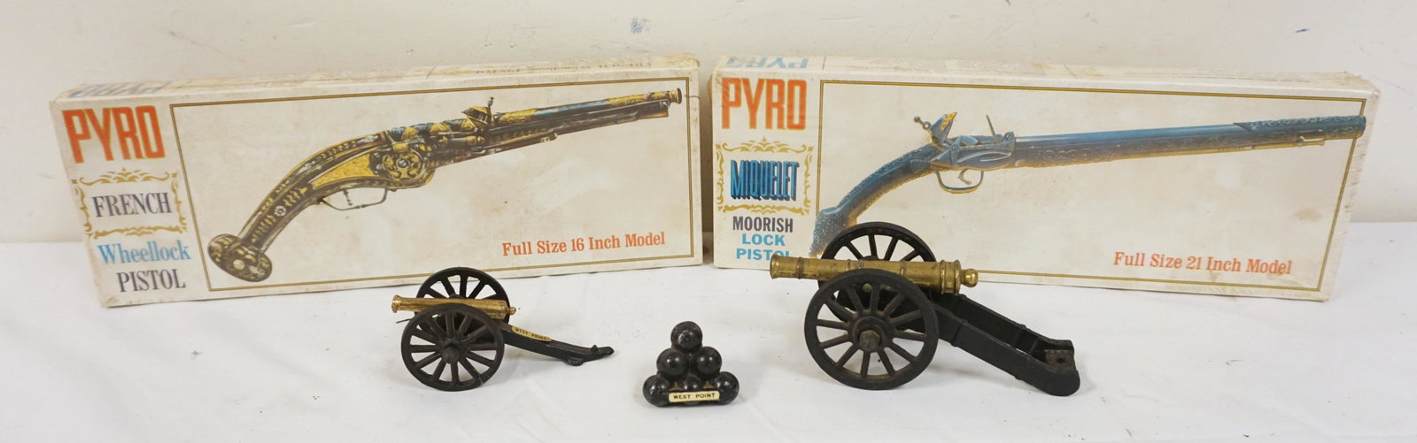 LOT INCLUDING 2 VINTAGE SEALED PISTOL KITS: LOT INCLUDING 2 VINTAGE SEALED PISTOL KITS, CAST METAL CANONS & CANON BALLS, 2 MARKED WEST POINT, LARGEST CANON APPROXIMATELY 7 IN X 3 IN HIGH