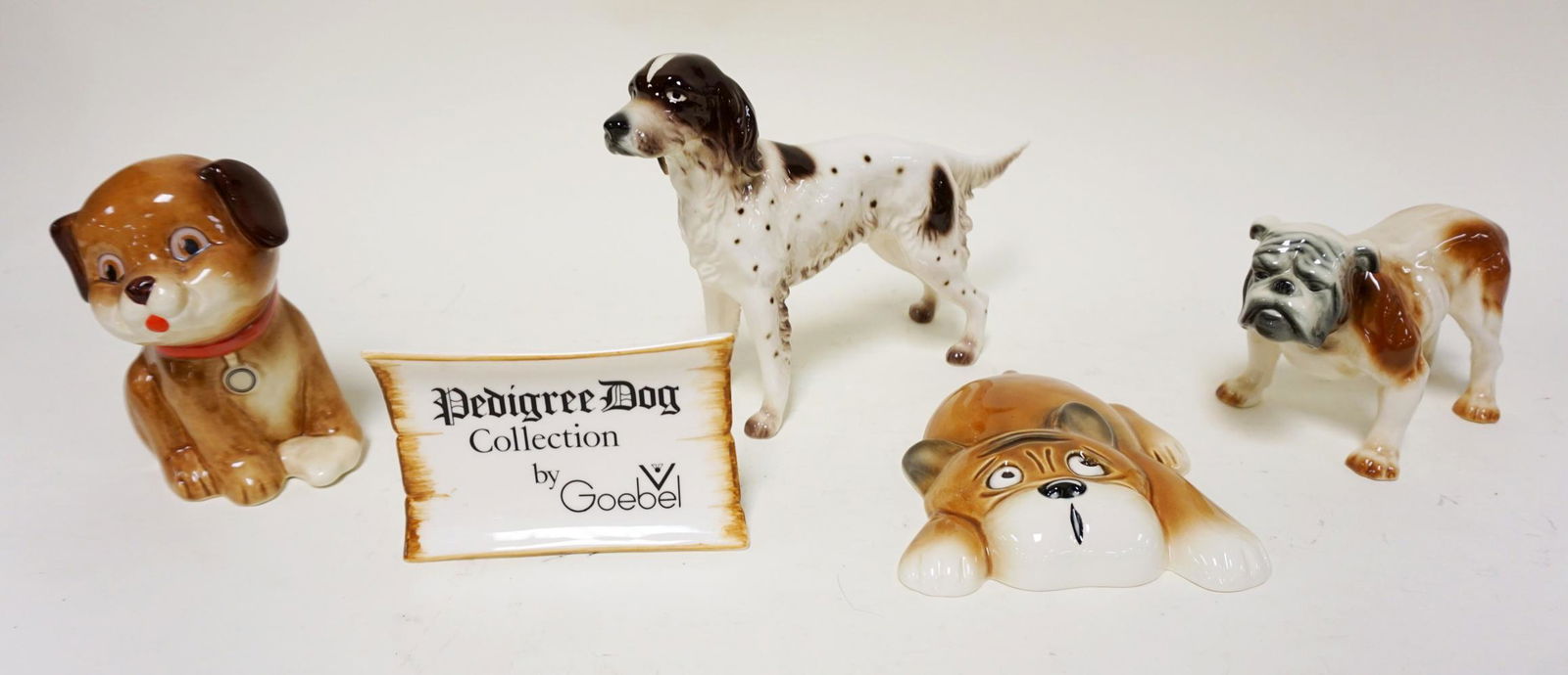 LOT OF 4 GOEBEL DOG FIGURINES & PLAQUE: LOT OF 4 GOEBEL DOG FIGURINES & PLAQUE, LARGEST APPROXIMATELY 7 IN HIGH