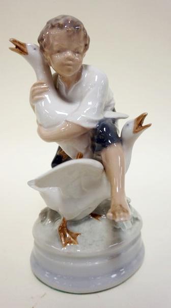 ROYAL COPENHAGEN FIGURINE: ROYAL COPENHAGEN FIGURINE OF YOUNG BOY WITH GEESE, APPROXIMATELY 7 IN H, SMALL NICK ON ONE GOOSE