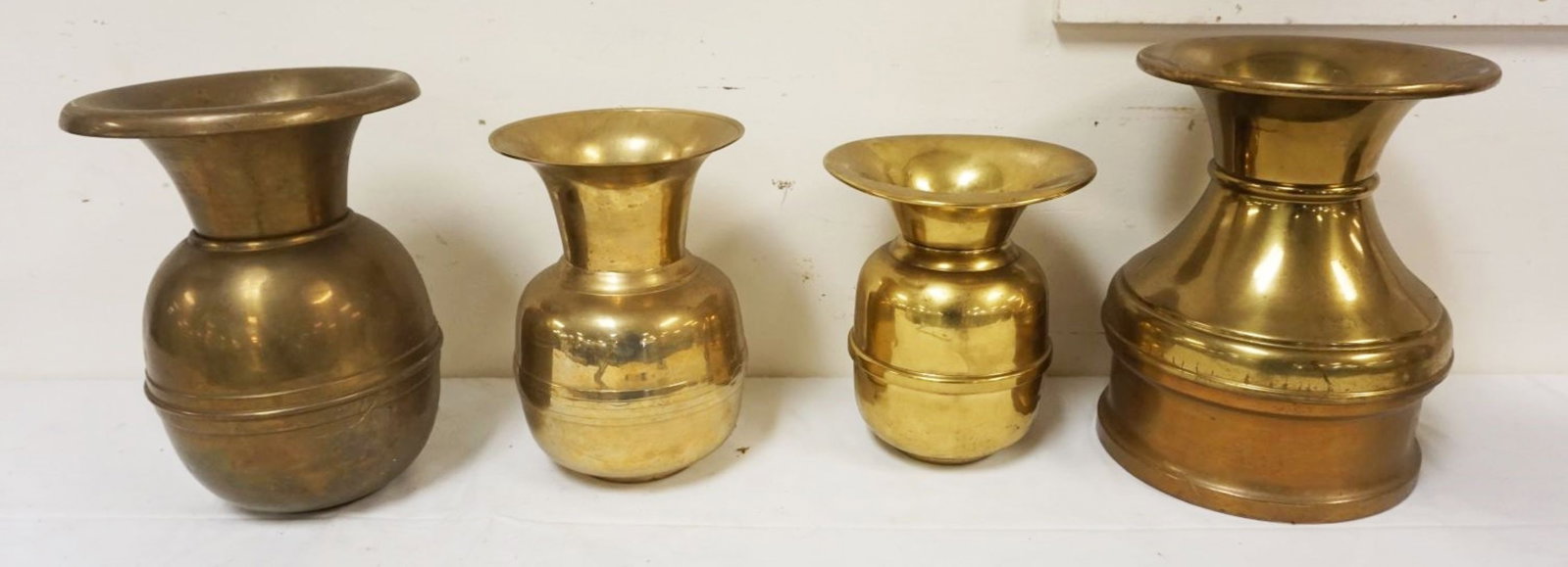 GROUP OF 4 BRASS SPITTOONS: GROUP OF 4 BRASS SPITTOONS, LARGEST APPROXIMATELY 12 IN HIGH