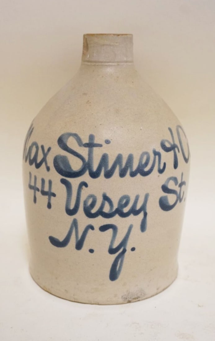 BLUE SCRIPT DECORATED STONEWARE JUG: BLUE SCRIPT DECORATED STONEWARE JUG, MAX STINER & CO NY, CHIP ON TOP SPOUT, APPROXIMATELY 9 1/4 IN HIGH