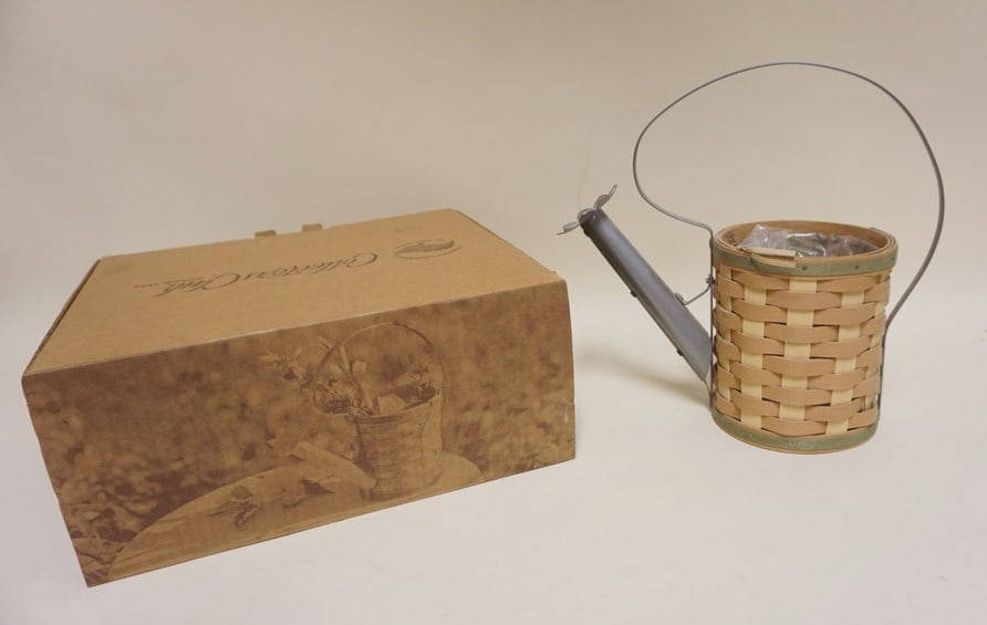 2011 WATERING CAN BASKET: 2011 WATERING CAN BASKET WITH PROTECTOR AND BOX, APPROXIMATELY 10 1/2 IN H, LIKE NEW