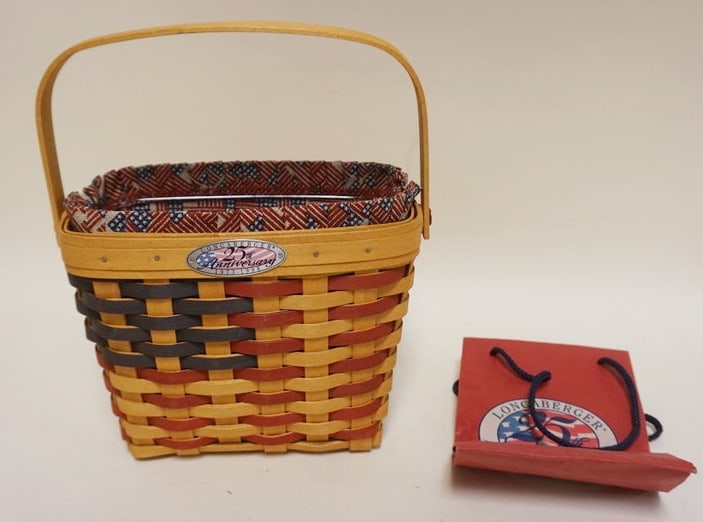 1998 25TH ANNIVERSARY FLAG BASKET: 1998 25TH ANNIVERSARY BASKET WITH LINER, PROTECTOR ANNIVERSARY BAG. SOME WEAR TO LINER. APPROXIMATELY 5 1/4 IN X 9 IN X 7 IN