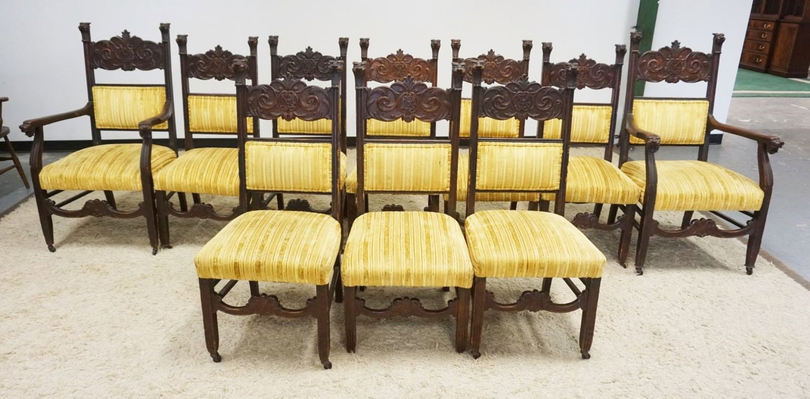 SET OF 10 CARVED OAK CHAIRS: SET OF 10 CARVED OAK CHAIRS W/LION HEADS AT TOP OF CHAIRS & ARM ENDS, 4 CHAIRS MISSING BOTTOM SIDE STRETCHER