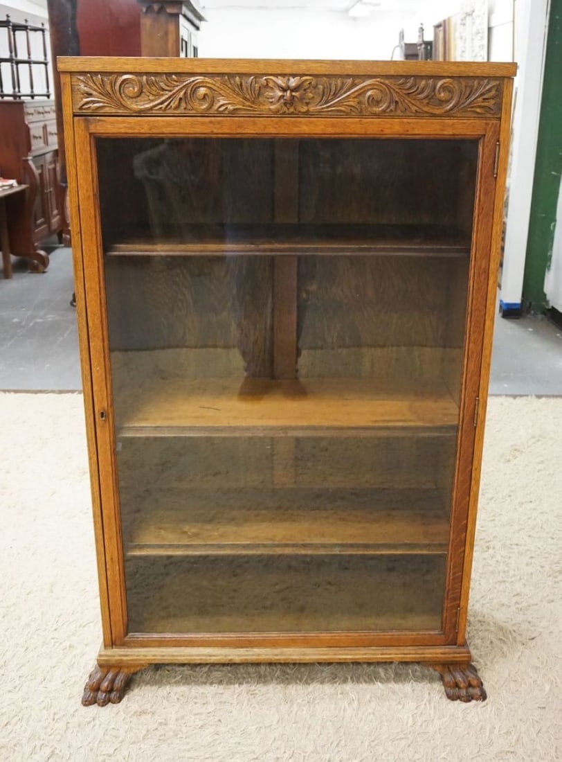 SOLID OAK NORTHWIND CARVED ONE DOOR BOOKCASE: SOLID OAK NORTHWIND CARVED ONE DOOR BOOKCASE W/ADJUSTABLE SHELVES & CLAW FOOT FRONT LEGS, APPROXIMATELY 35 IN X 15 IN X 57 IN HIGH