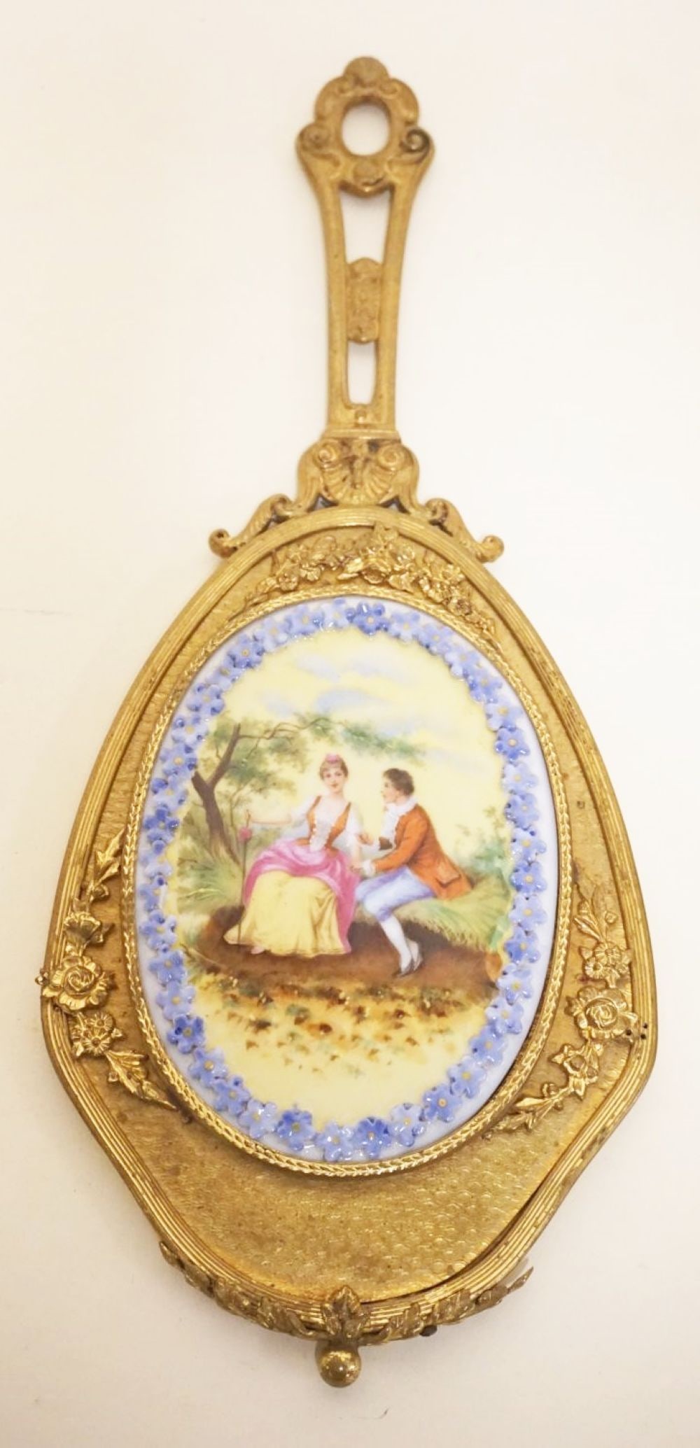 LADY'S MIRROR: LADY'S MIRROR W/HAND PAINTED PORCELAIN MEDALION BACK OF COURTING SCENE & RAISED FLORAL BORDER, APPROXIMATELY 12 IN X 5 IN