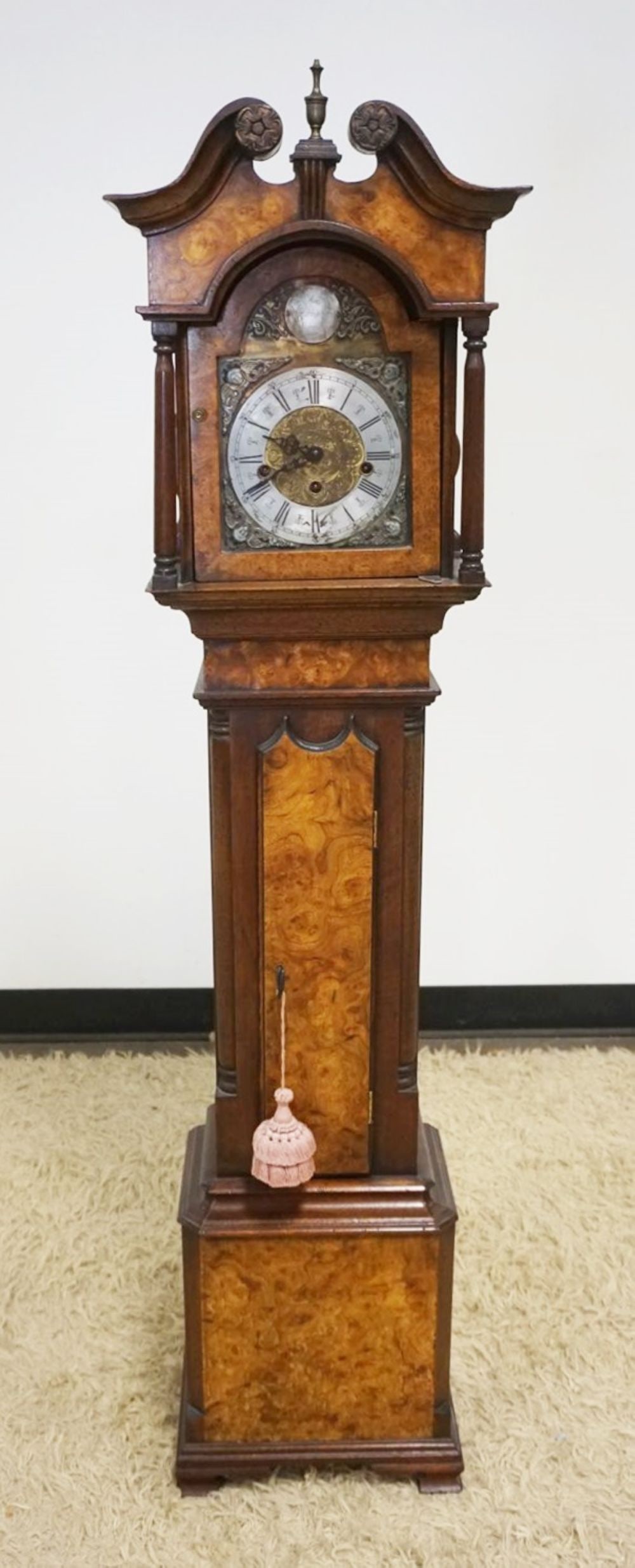 GRANDMOTHERS CLOCK IN BURLED WALNUT CASE: DIMINUATIVE GRANDMOTHERS CLOCK IN BURLED WALNUT CASE WITH QUARTER COLUMN SIDES, CLOCK FACE MARKED JOHN THOMPSON, LONDON, APPROXIMATELY 9 IN X 13 IN X 58 IN H
