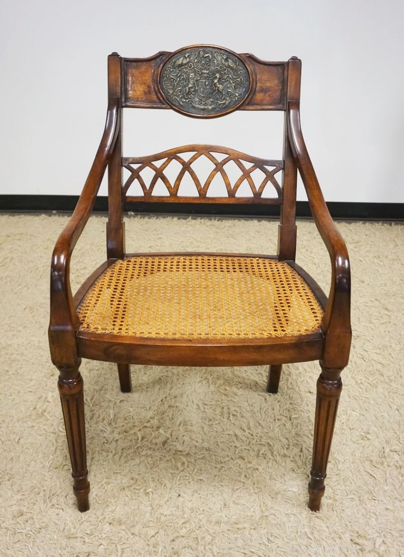 MAHOGANY ARM CHAIR: MAHOGANY ARM CHAIR WITH CANE SEAT AND INSET RELIEF METAL MEDALION ON CHAIR CREST, CANE SEAT IN GOOD CONDITION