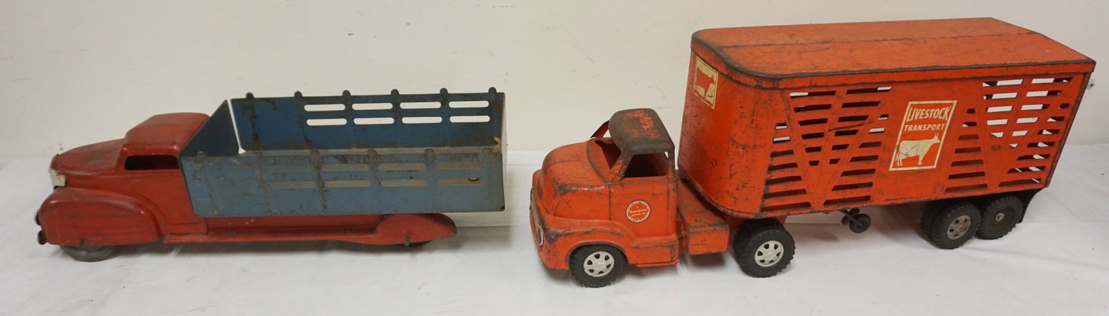 2 ANTIQUE PRESSED STEEL TOY TRUCKS: 2 ANTIQUE PRESSED STEEL TOY TRUCKS, LIVE STOCK & STAKE BODY, LARGEST APPROXIMATELY 23 IN LONG
