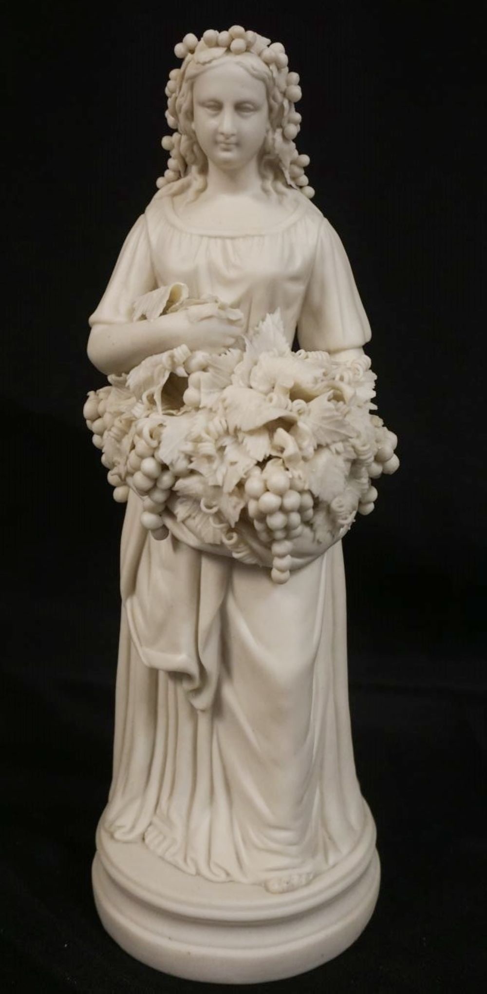 PARIAN FIGURE OF WOMAN HOLDING GRAPE CLUSTERS: PARIAN FIGURE OF WOMAN HOLDING GRAPE CLUSTERS, APPROXIMATELY 13 1/2 IN HIGH