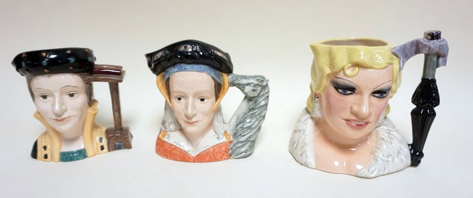 3 ROYAL DOULTON TOBIES: 3 ROYAL DOULTON TOBIES, CATHERINE PARR, ANNE OF CLEVES, MAE WEST, TALLEST APPROXIMATELY 7 3/4 IN