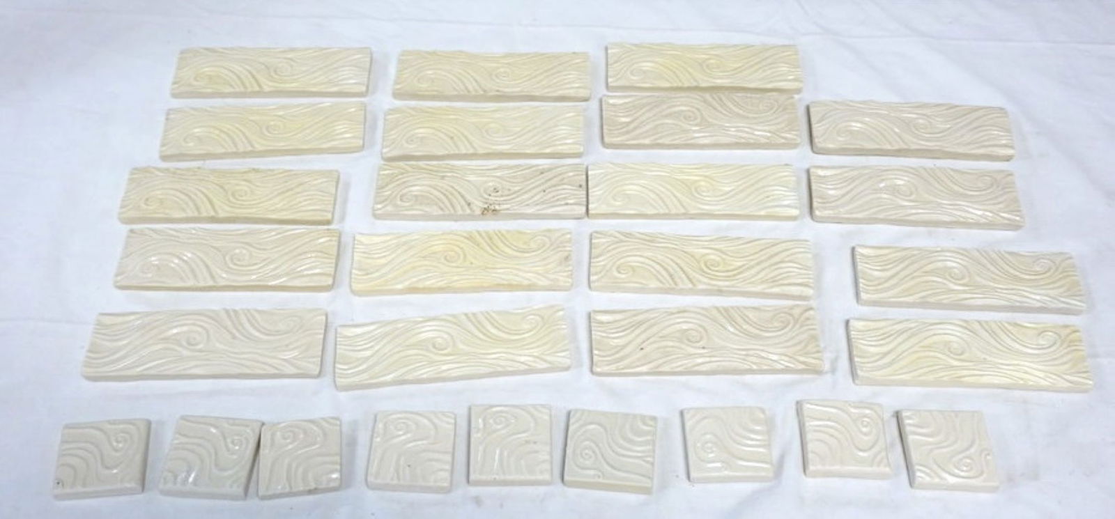 NATALIE SURVING ARCHITECTURAL TILES: NATALIE SURVING ARCHITECTURAL TILES, SURVING STUDIOS, LARGEST APPROXIMATELY 6 IN X 2 IN, 28 TILES