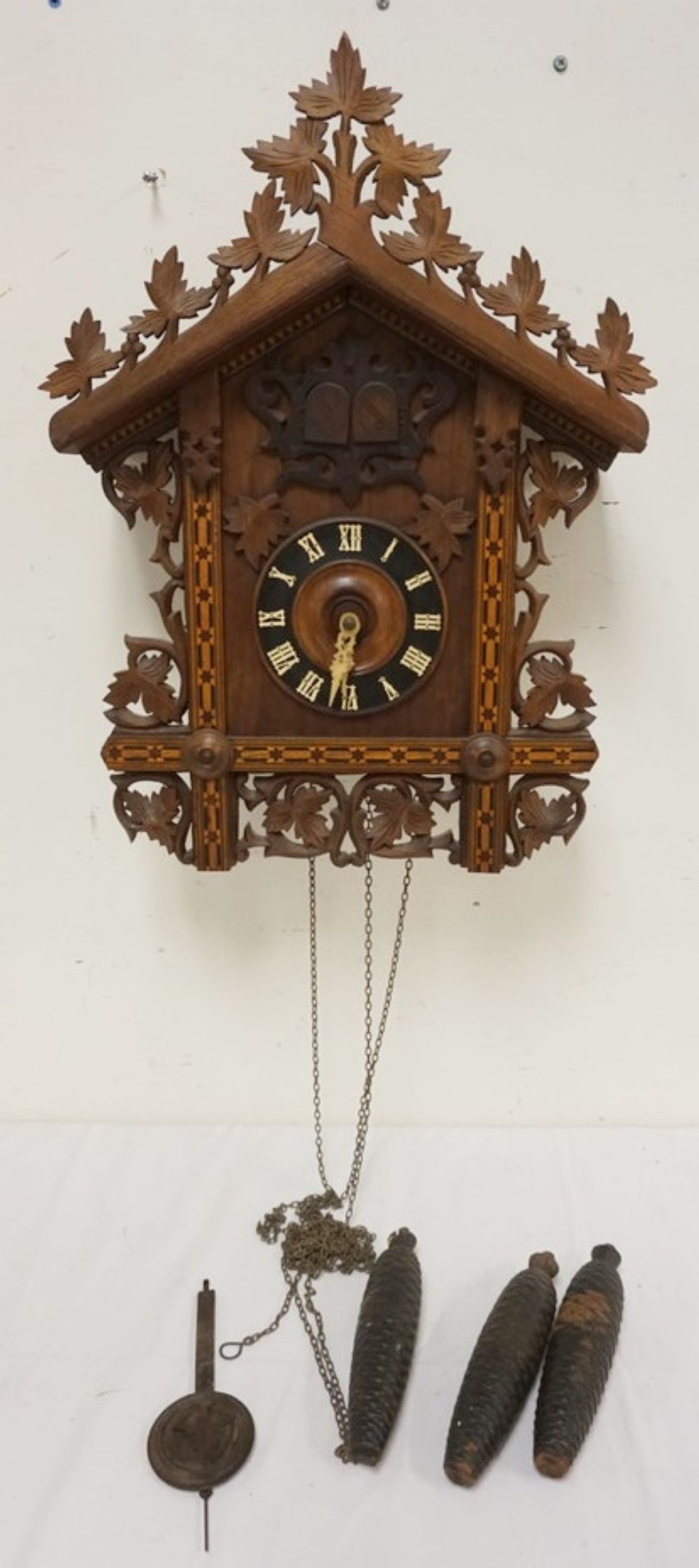 CARVED CUCKOO CLOCK: CARVED CUCKOO CLOCK, SOME LOSS TO CARVING, SOLD AS FOUND FOR RESTORATION, APPROXIMATELY 12 IN X 8 IN X 25 IN HIGH
