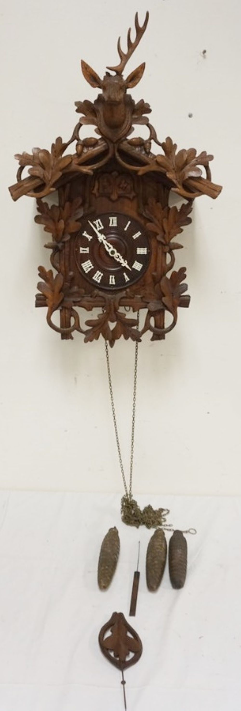 CARVED CUCKOO CLOCK: CARVED CUCKOO CLOCK, SOME LOSS TO CARVING, SOLD AS FOUND FOR RESTORATION, APPROXIMATELY 17 IN X 12 IN X 24 IN HIGH