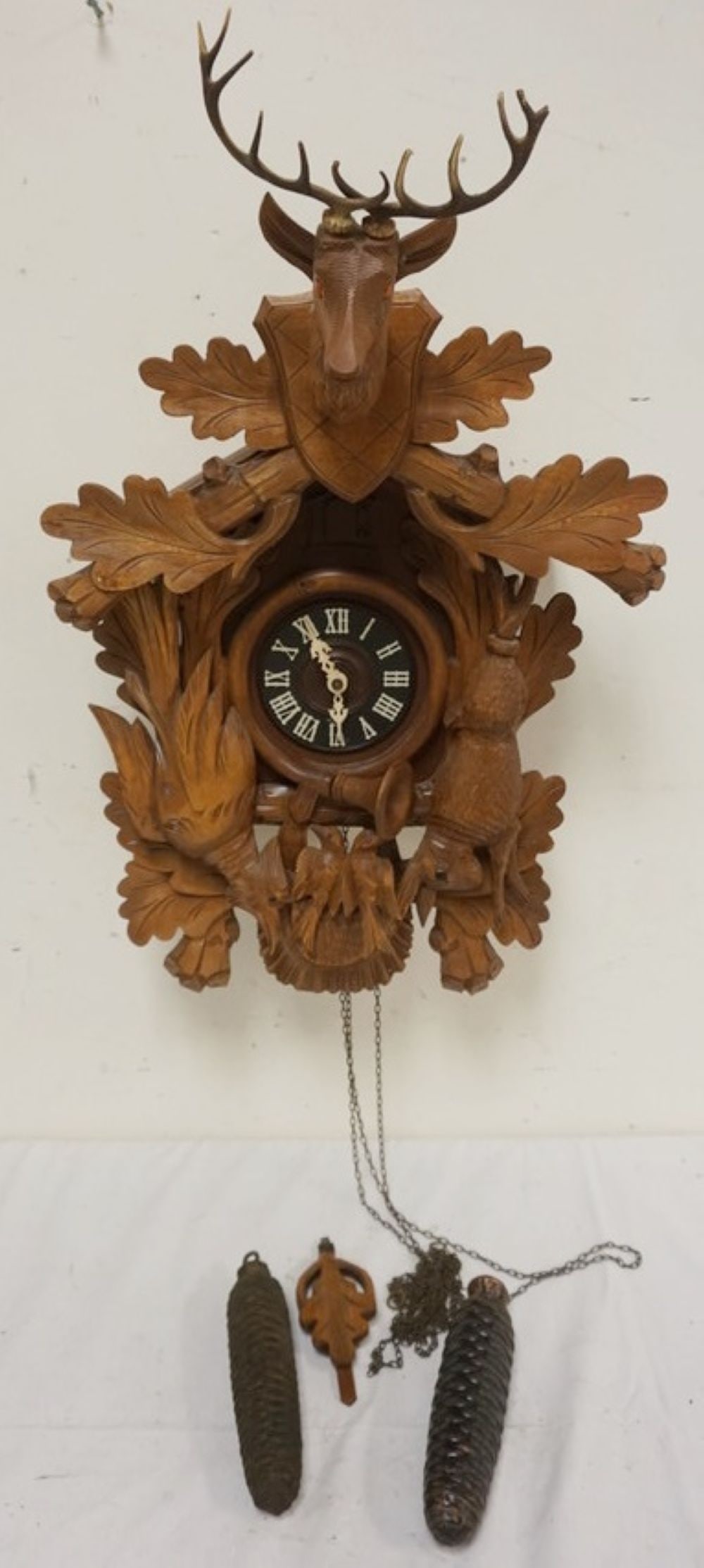 CARVED CUCKOO CLOCK: CARVED CUCKOO CLOCK, SOME LOSS TO CARVING, SOLD AS FOUND FOR RESTORATION, APPROXIMATELY 16 IN X 10 IN X 26 IN HIGH