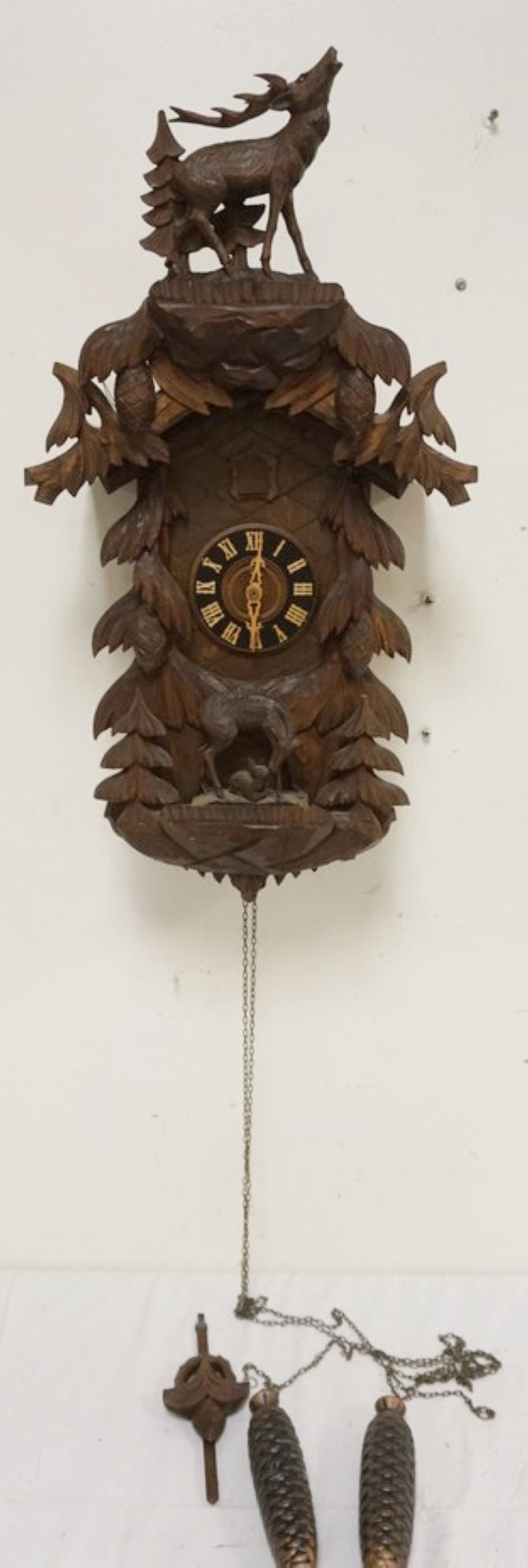 CARVED CUCKOO CLOCK: CARVED CUCKOO CLOCK, SOME LOSS TO CARVING, SOLD AS FOUND FOR RESTORATION, APPROXIMATELY 15 IN X 7 IN X 26 IN HIGH