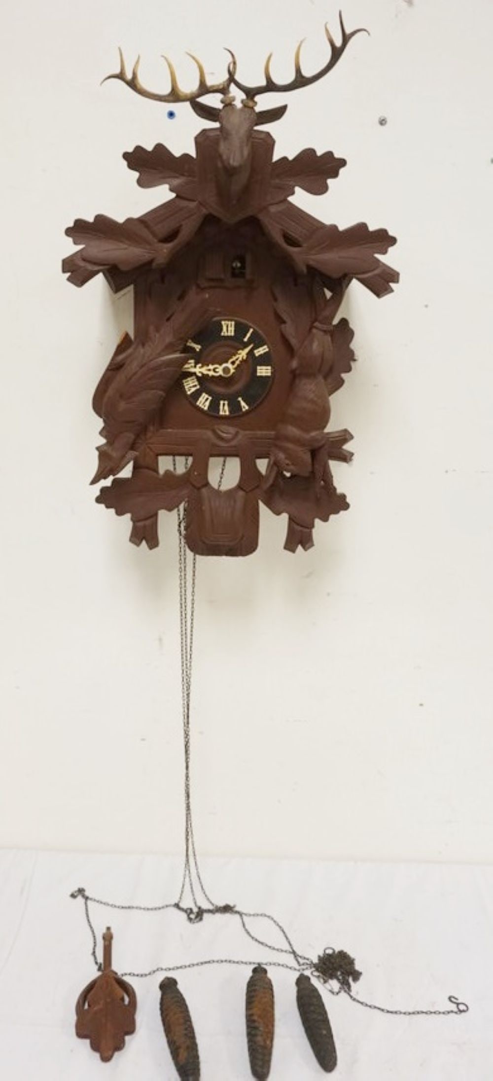 CARVED CUCKOO CLOCK: CARVED CUCKOO CLOCK, SOME LOSS TO CARVING, SOLD AS FOUND FOR RESTORATION, APPROXIMATELY 14 IN X 12 IN X 21 IN HIGH
