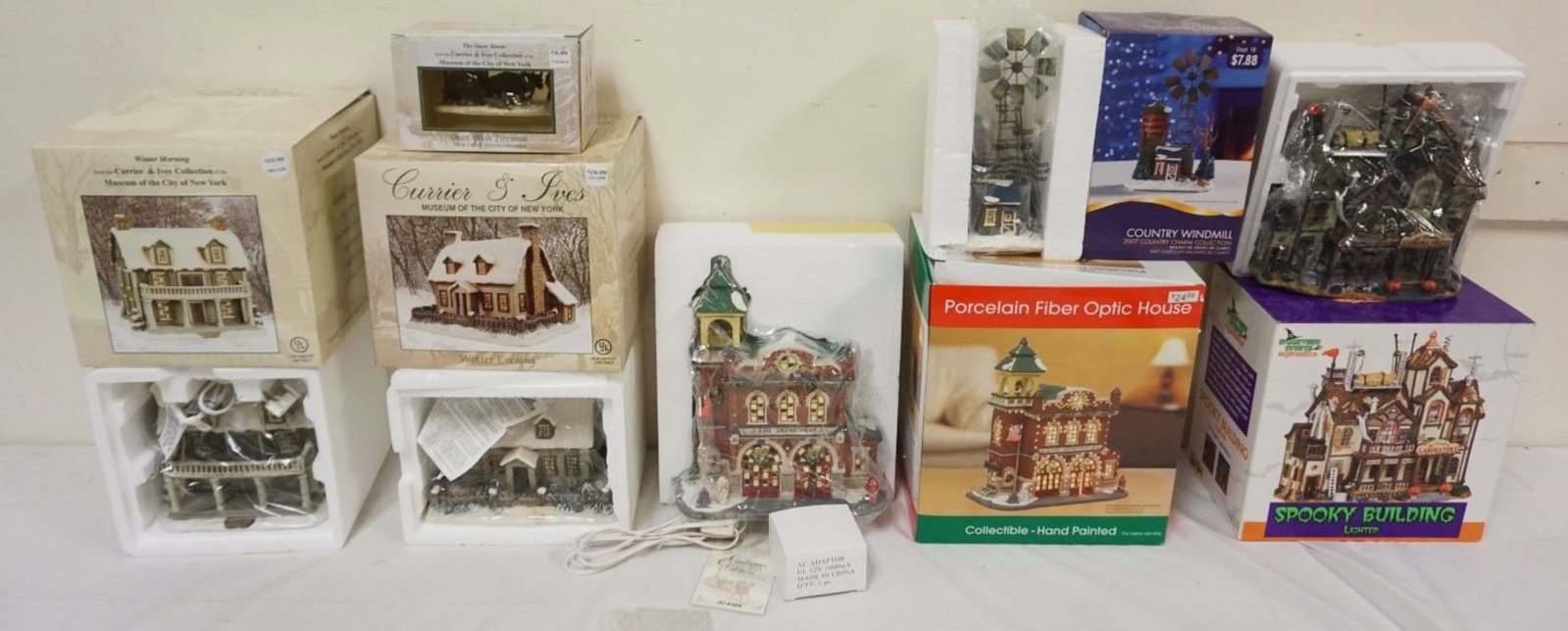 GROUP OF 7 ASSORTED HOLIDAY PORCELAIN BUILDINGS: GROUP OF 7 ASSORTED HOLIDAY PORCELAIN BUILDINGS & FIXTURES INCLUDING CURRIER & IVES & HALLOWEEN