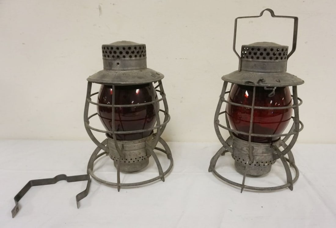 DEITZ RAILROAD LANTERNS: 2 DEITZ RAILROAD LANTERNS WITH RED GLOBES, BOTH STAMPED *CITY OF NEW YORK*, APPROXIMATELY 12 IN H, 1 WITH DETACHED HANDLE