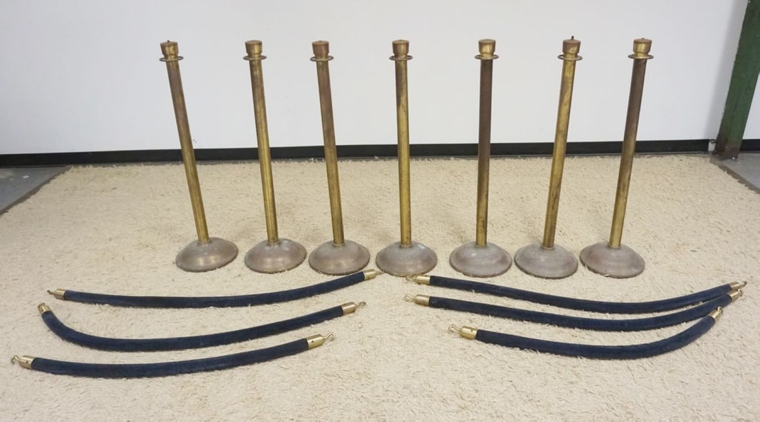 7 BRASS SHEATHED STANCHIONS: GROUP OF 7 BRASS SHEATHED STANCHIONS, EACH APPROXIMATELY 41 IN H X 12 IN ROUND BASE, BARRIER LENGTH AVERAGE 48 IN