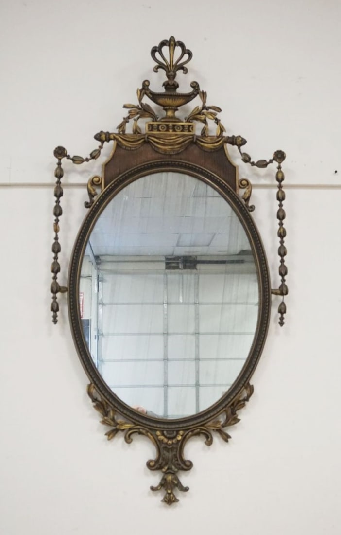ORNATE HANGING MIRROR: ORNATE HANGING MIRROR WITH URN AND BELL FLOWER TRIM, SILVERING ON MIRROR WORN, APPROXIMATELY 28 IN X 56 IN H