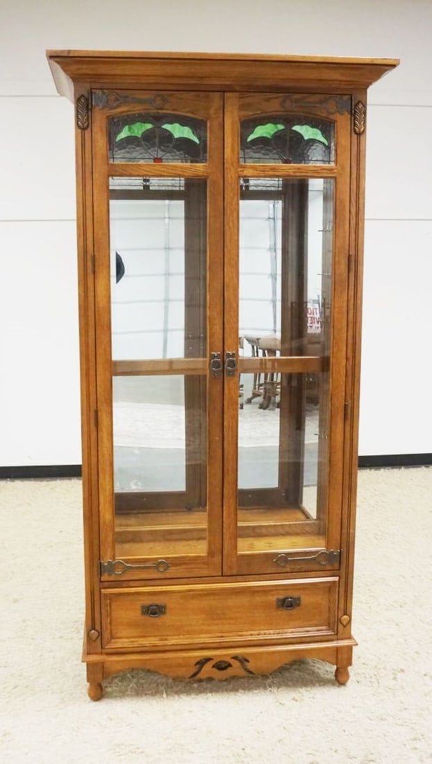 PULASKI OAK CRYSTAL CABINET: PULASKI OAK 2 DOOR CRYSTAL CABINET WITH LOWER DRAWER AND BEVELED GLASS DOORS WITH SLAG AND ICED GLASS TOP, ADJUSTABLE SHELVES WITH INTERIOR LIGHTS, APPROXIMATELY 42 IN X 17 IN X 84 IN H