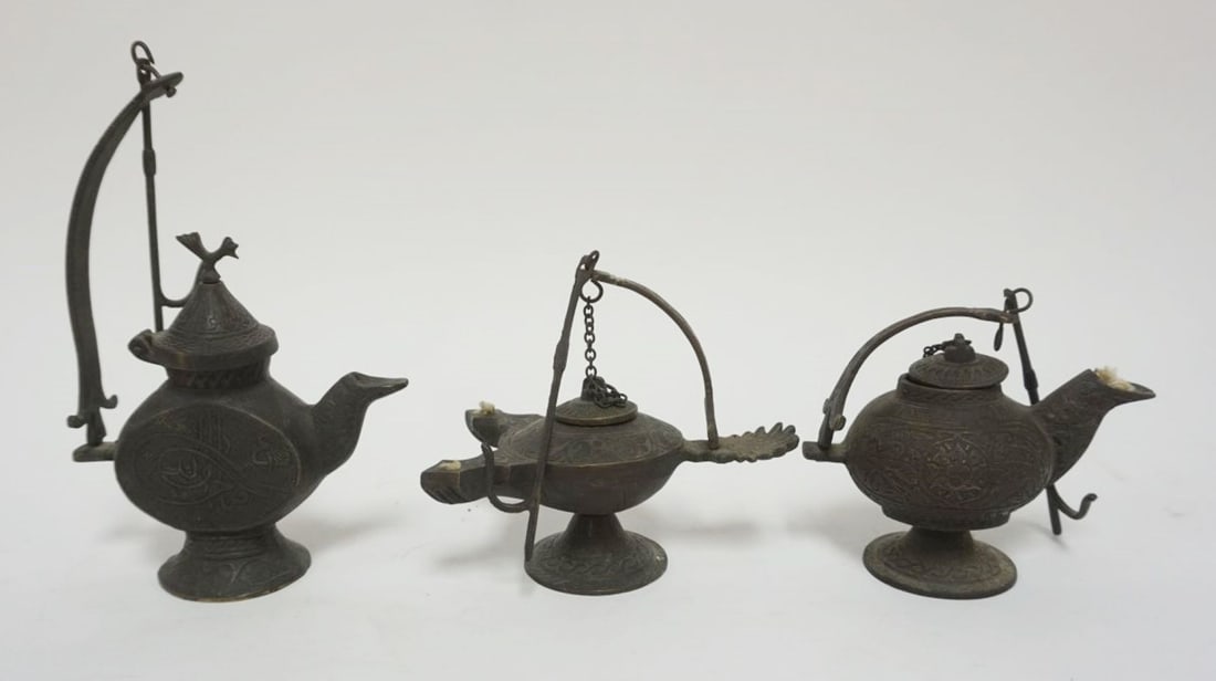 GROUP OF BRONZE OIL LAMPS: GROUP OF BRONZE OIL LAMPS, LARGEST APPROXIMATELY 8 IN