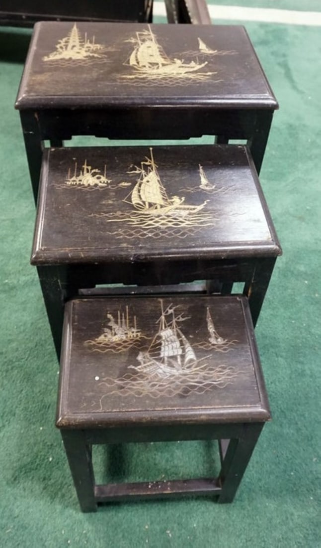 NEST OF 3 LACQUERED ASIAN TABLES: NEST OF 3 LACQUERED ASIAN TABLES W/METAL INLAY OF SAILING SHIPS, FINISH WORN ON TOP, APPROXIMATELY 17 IN X 13 IN X 23 IN