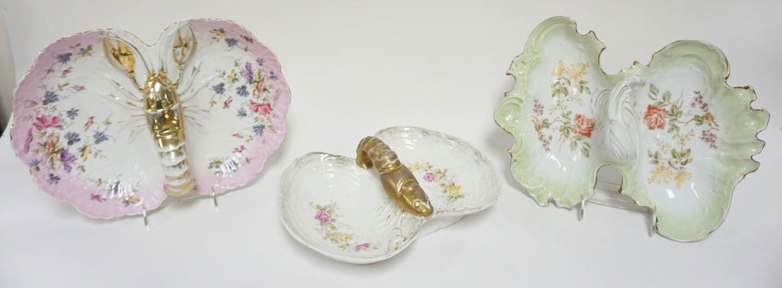 GROUP OF 3 LOBSTER DISHES: GROUP OF 3 LOBSTER DISHES DECORATED W/IMAGES OF FLOWERS, 2 WTH LOBSTER CENTER HANDLES, ONE MARKED KPM & CT GERMANY, LARGEST APPROXIMATELY 14 IN X 11 IN X 5 IN