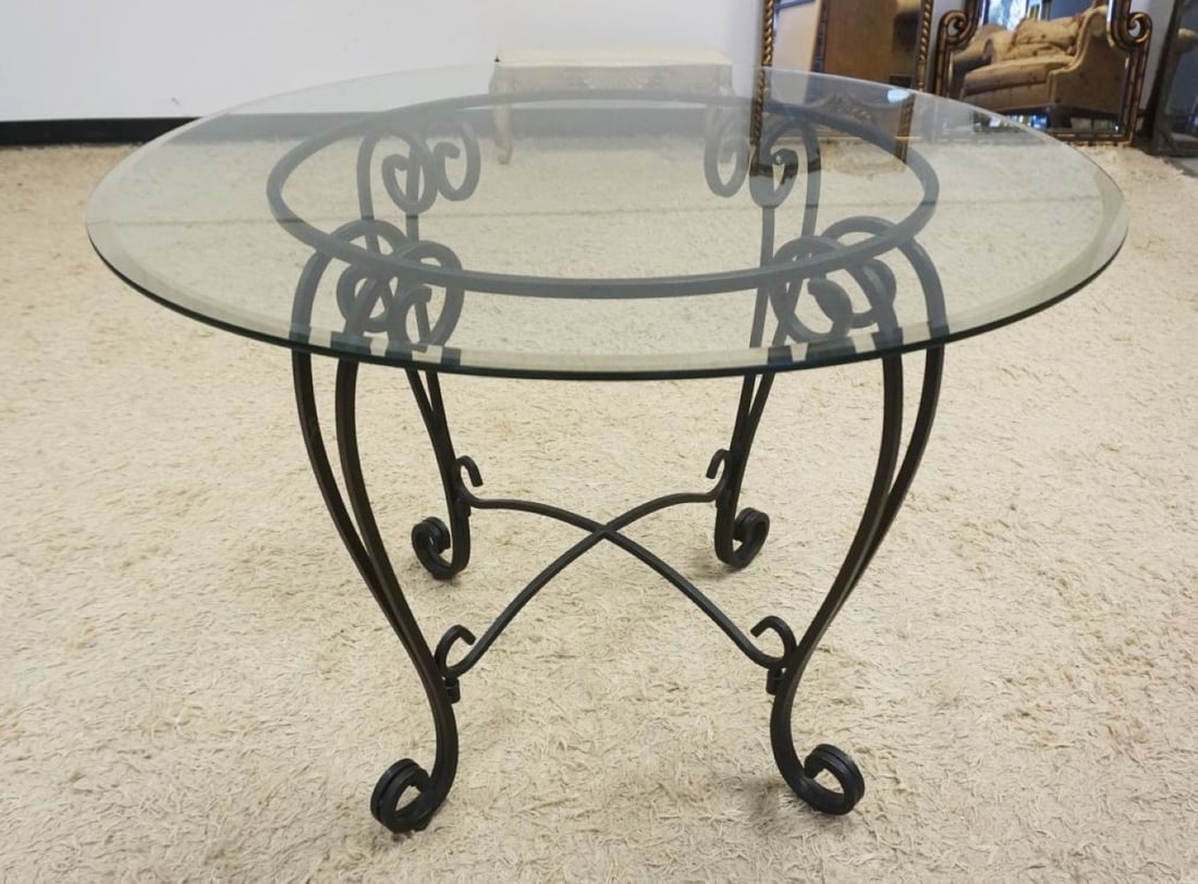 GLASS TOP WROUGHT IRON BASE TABLE: GLASS TOP BEVELED EDGE TABLE WITH WROUGHT IRON BASE, APPROXIMATELY 42 IN X 30 IN H