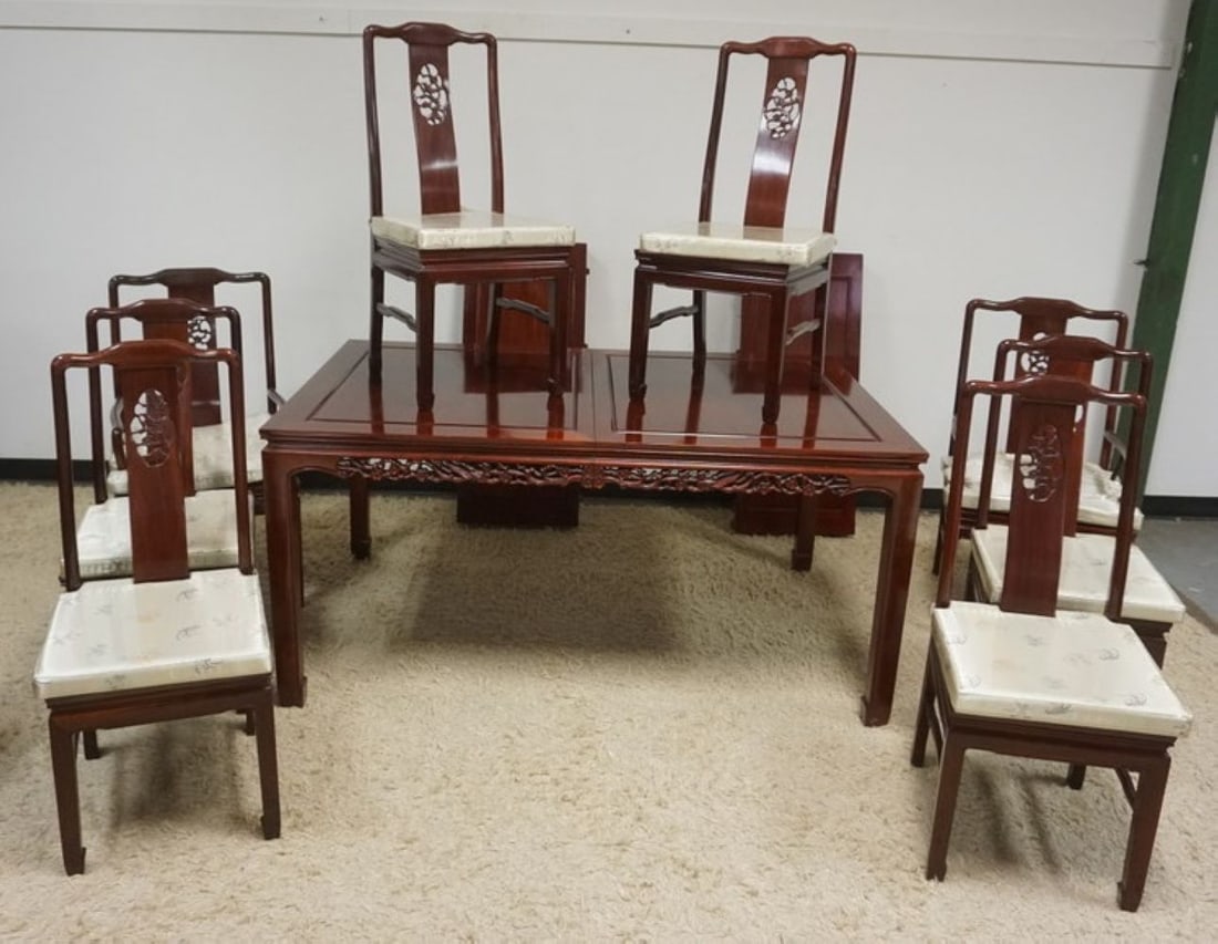 CARVED ASIAN DINING TABLE AND CHAIRS: CARVED ASIAN DINING TABLE AND CHAIRS WITH 2 LEAVES, CHAIRS HAVE PIERCED CARVED BENTWOOD BACKS AND UPHOLSTERED SEATS. TABLE HAS FLORAL PIERCED CARVED SKIRT, TABLE APPROXIMATELY 64 IN X 42 IN X 31 N H E