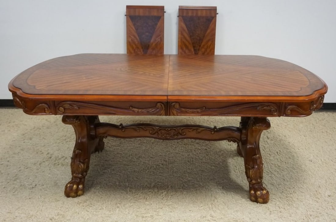 OAK DINING TABLE: OAK DINING TABLE WITH BOOK MATCHED VENEER TOP, CARVED SKIRT, CARVED PAW FEET WITH GILT ACCENTS, AND 2 LEAVES, TABLE APPROXIMATELY 78 IN X 46 IN X 32 IN H, EACH LEAVE APPROXIMATELY 16 IN W
