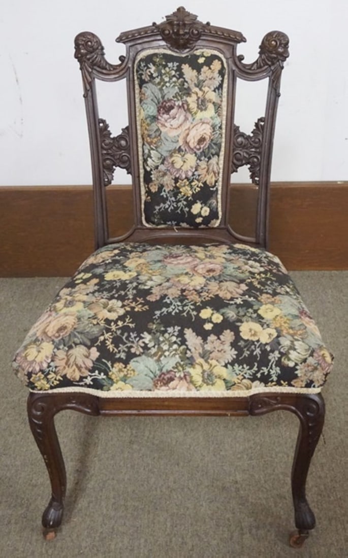 VICTORIAN WALNUT UPHOLSTERED PARLOR CHAIR: VICTORIAN WALNUT UPHOLSTERED PARLOR CHAIR WITH CARVED HEADS AND NORTH WIND FACE AT SIDES AND CENTER, APPROXIMATELY 23 IN X 21 IN X 39 IN H