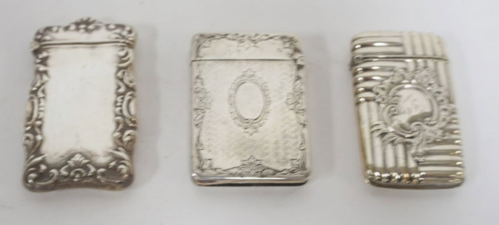 REPOUSSE STERLING MATCH SAFES: GROUP OF 3 REPOUSSE STERLING MATCH SAFES, 3 OZT