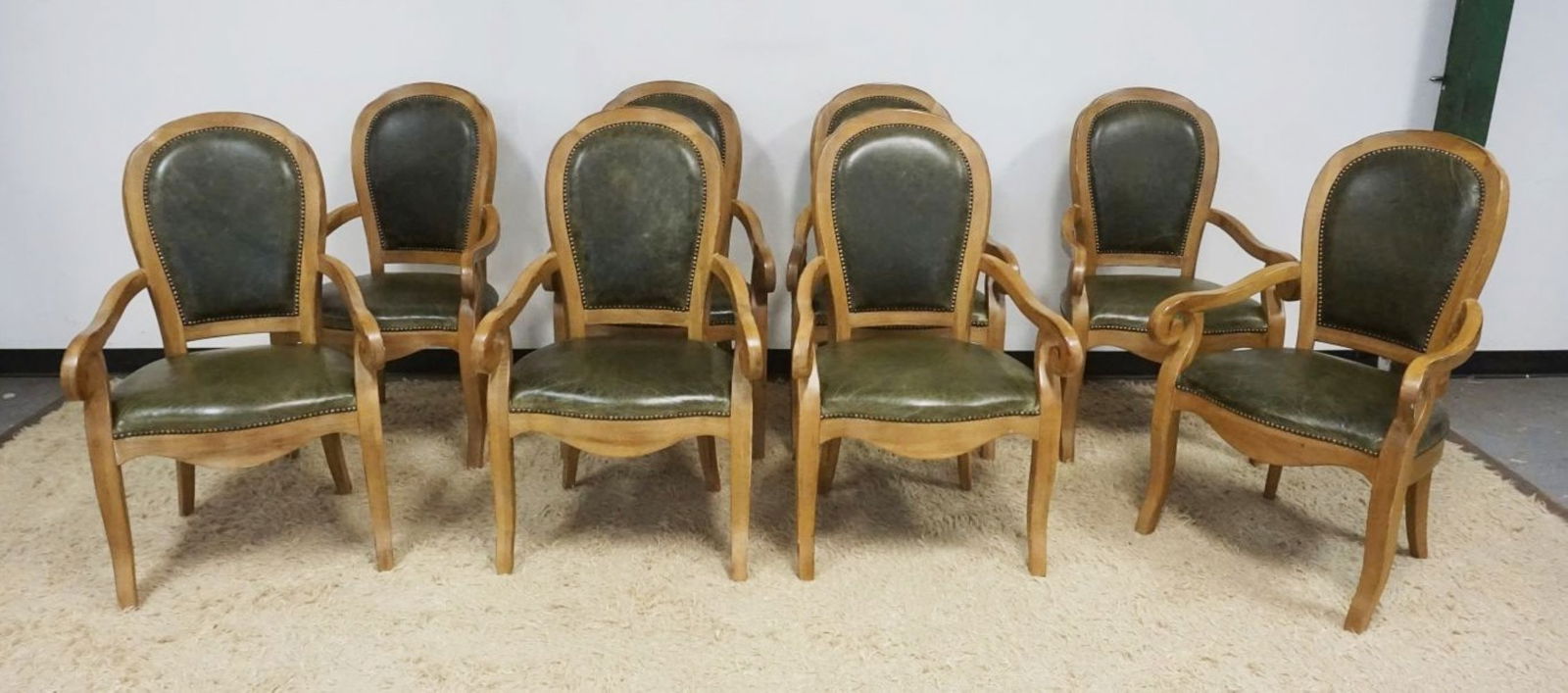 OAK SCROLLED ARM CHAIRS: SET OF 8 OAK SCROLLED ARM CHAIRS WITH GREEN LEATHER BOTTOMS AND BACKS, BRASS TACK ACCENTS, APPROXIMATELY 23 3/4 IN X 21 IN X 40 1/2 IN