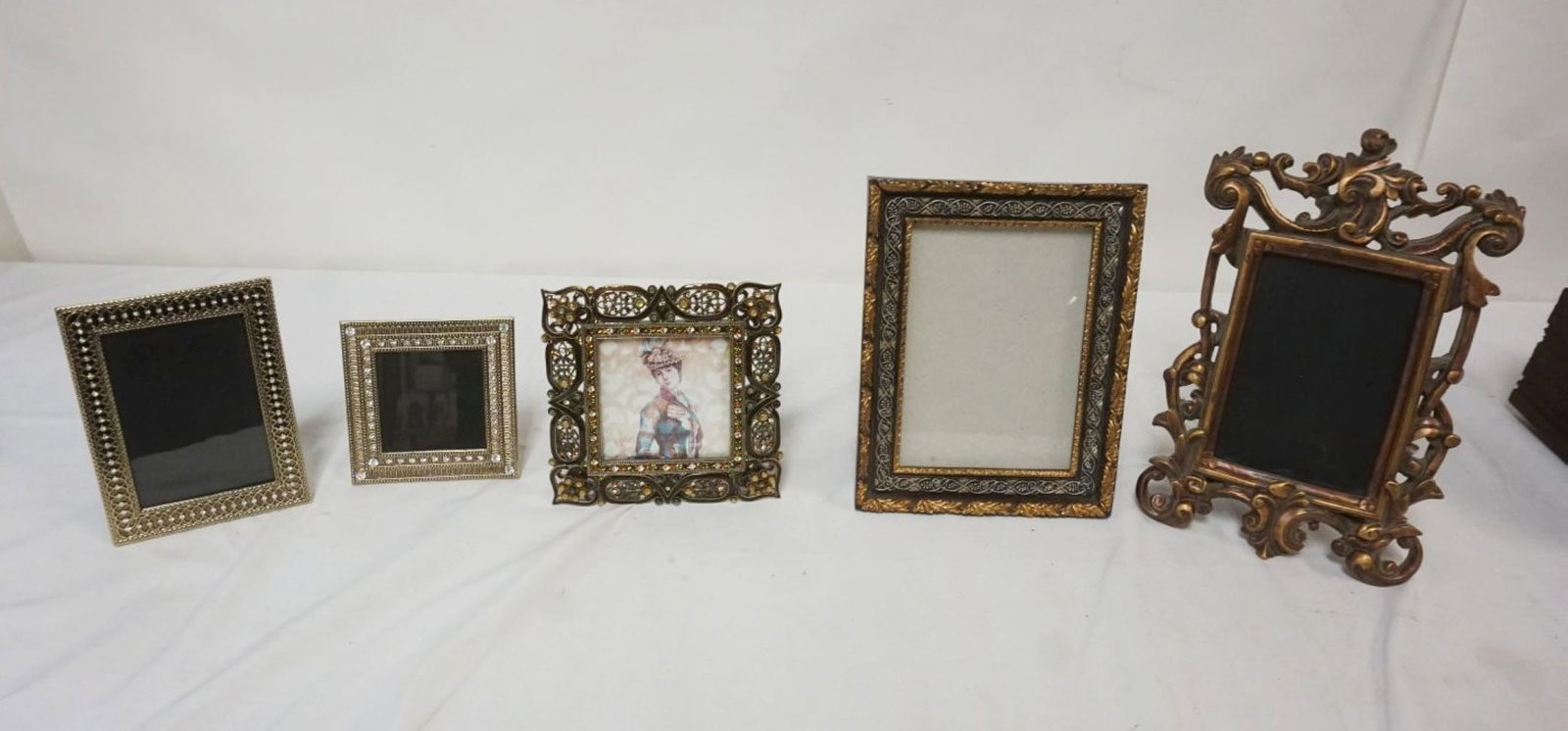 GROUP OF 5 DECORATIVE DRESSER TOP PHOTO FRAMES: GROUP OF 5 DECORATIVE DRESSER TOP PHOTO FRAMES, 3 ARE JEWELED, LARGEST APPROXIMATELY 11 1/4 IN X 7 IN