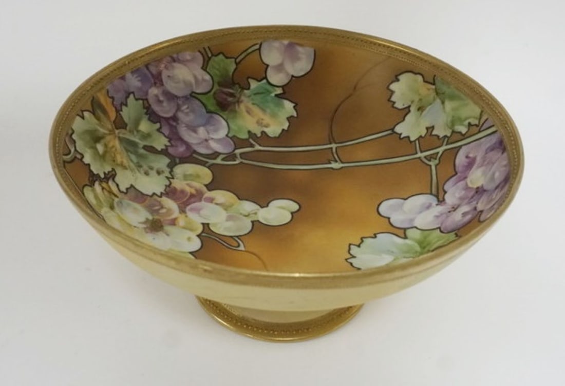 HAND PAINTED NIPPON COMPOTE: HAND PAINTED NIPPON COMPOTE WITH IMAGES OF GRAPES ON FOOTED PEDESTAL, APPROXIMATELY 10 IN X 7 1/4 IN H