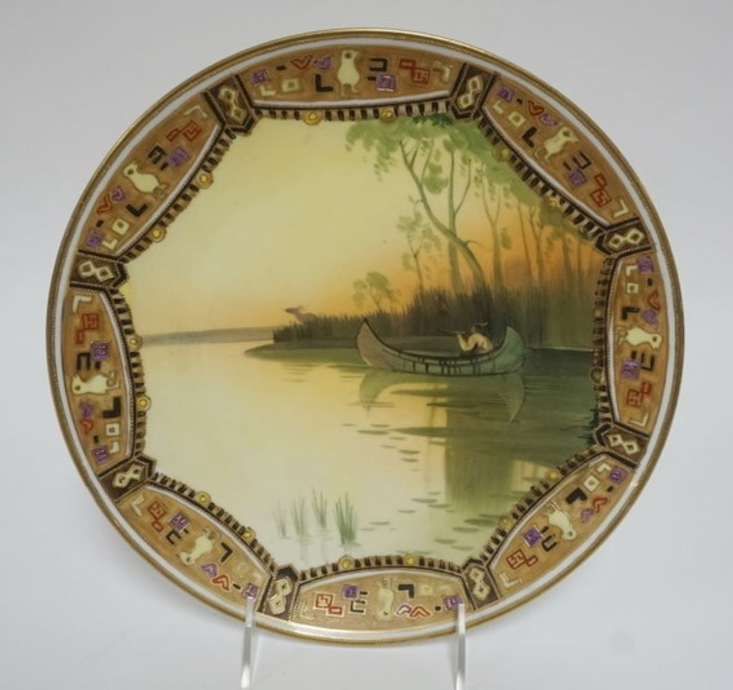 HAND PAINTED NIPPON WALL PLAQUE: HAND PAINTED NIPPON WALL PLAQUE, IMAGE OF AMERICAN INDIAN HUNTING ELK IN BIRCH CANOE, APPROXIMATELY 10 1/2 IN, PIERCED FOR HANGING