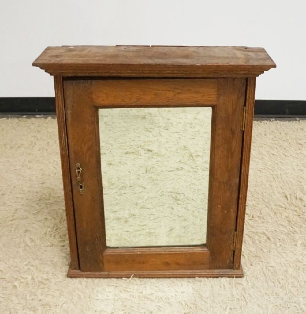 ANTIQUE NARROW OAK HANGING CABINET: ANTIQUE NARROW OAK HANGING CABINET W/MIRROR DOOR, APPROXIMATELY 23 IN X 6 1/2 IN X 27 IN